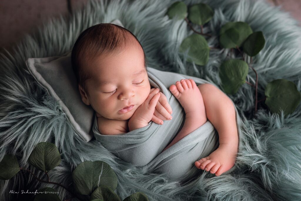 cozy newborn posing 